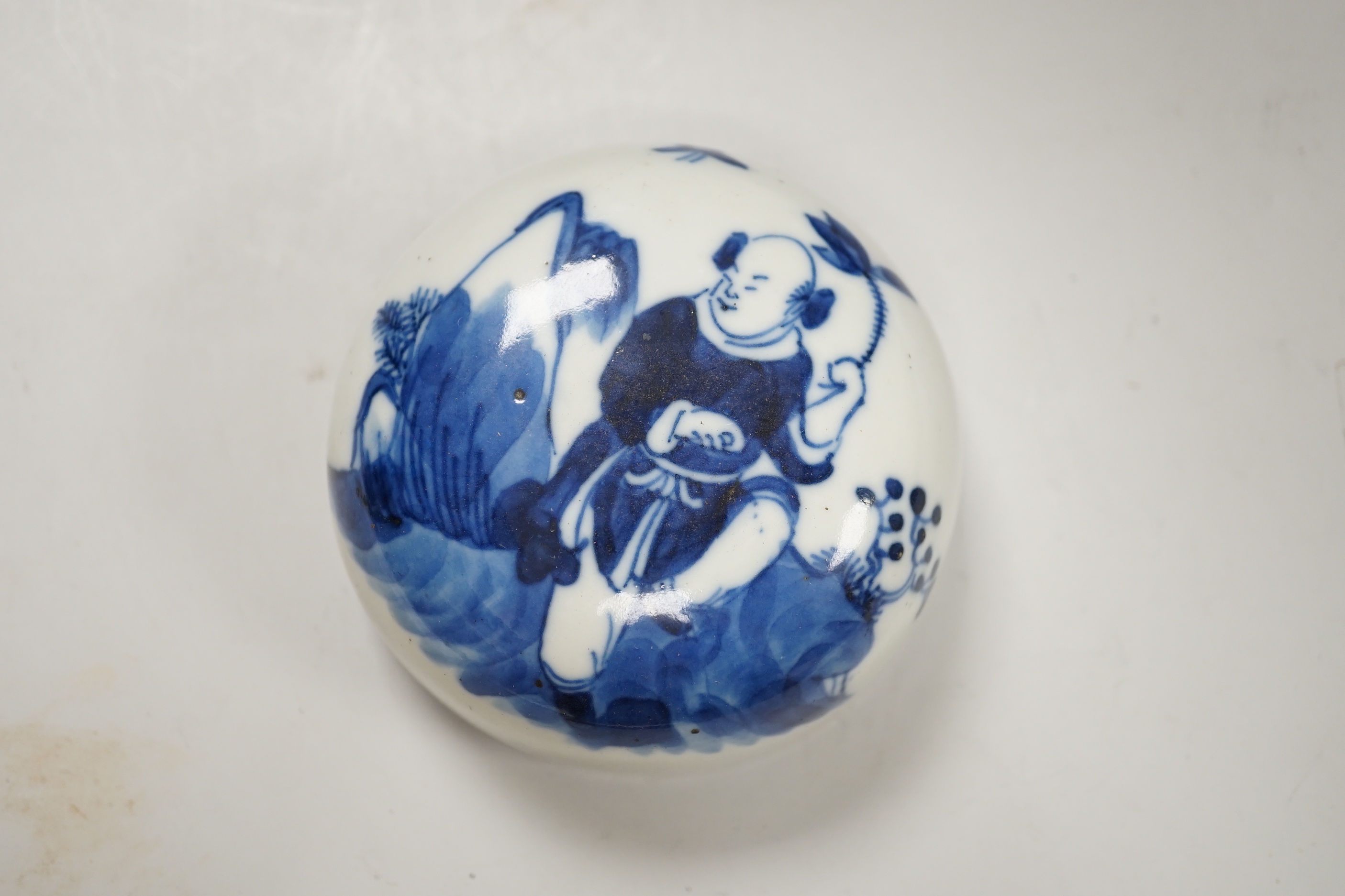 A 19th century Chinese blue and white jar and cover, hand painted with figures in a landscape, 20cm high